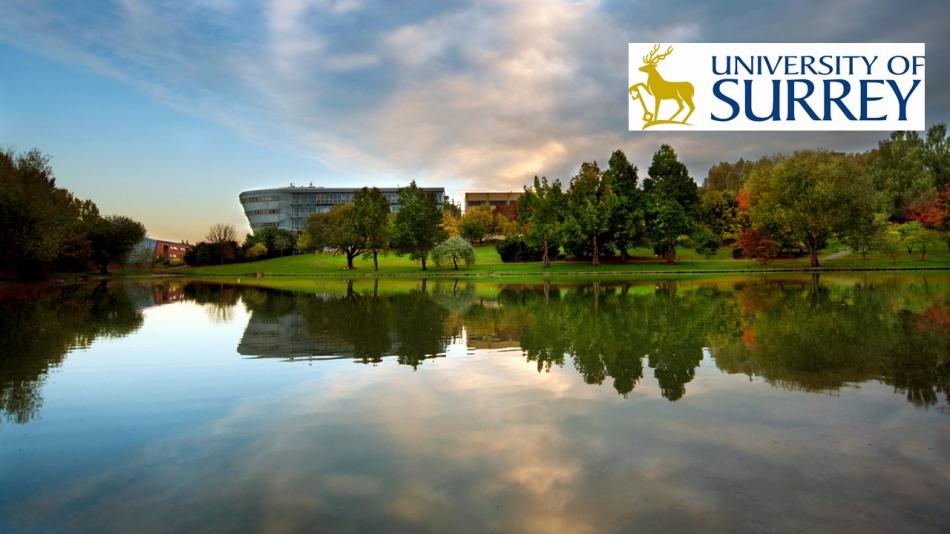 Photo of the University of Surrey depicting a lake, with the logo included